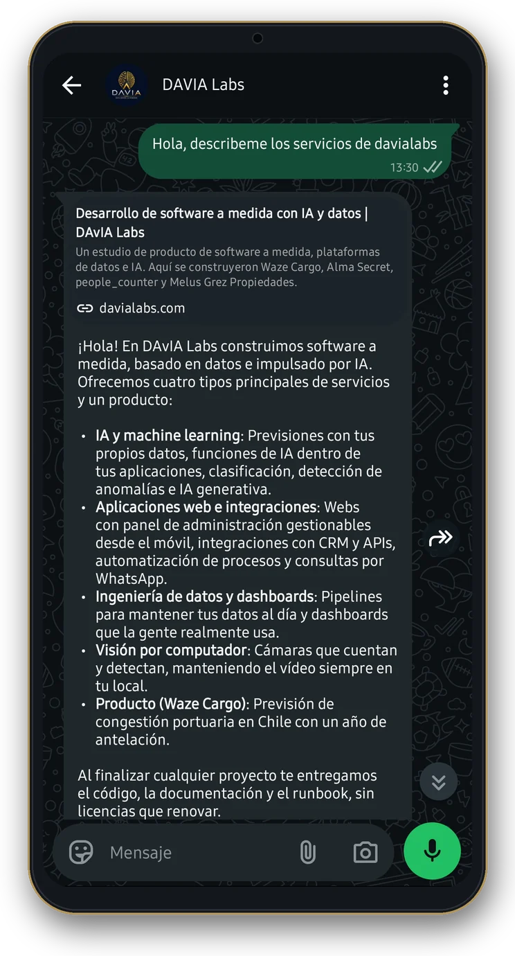A phone showing a WhatsApp chat with DAvIA Labs. The visitor writes Hola, describeme los servicios de davialabs, and the assistant answers in Spanish with the four services, AI and machine learning, web apps and integrations, data engineering and dashboards, and computer vision, plus the Waze Cargo product, under a link preview of davialabs.com.